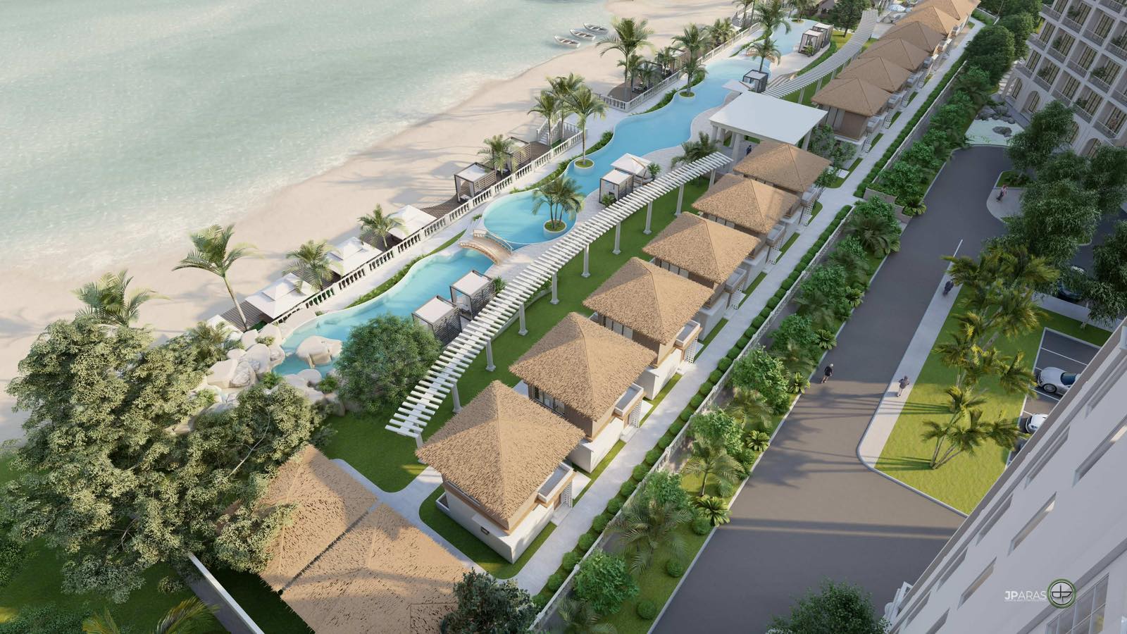 Lower aerial view over the infinity pool, cabanas and thatched villa roofs, with the sea washing the sand along the left.