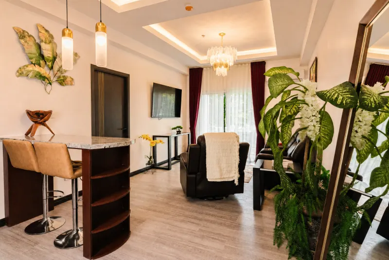 Living area with breakfast bar and tropical planting