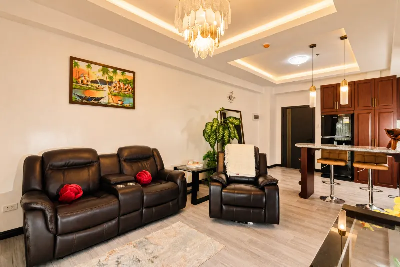 Lounge with deep leather seating and gilded chandelier