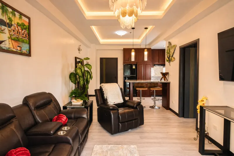 Leather recliners beneath a gold chandelier