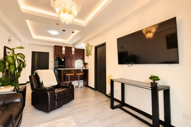 Living room with wall-mounted television and console