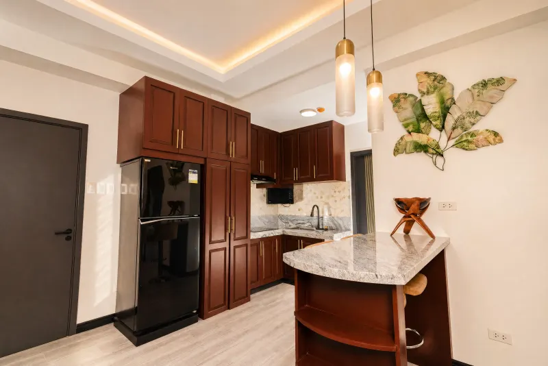 Kitchen with pendant lighting and leaf motifs