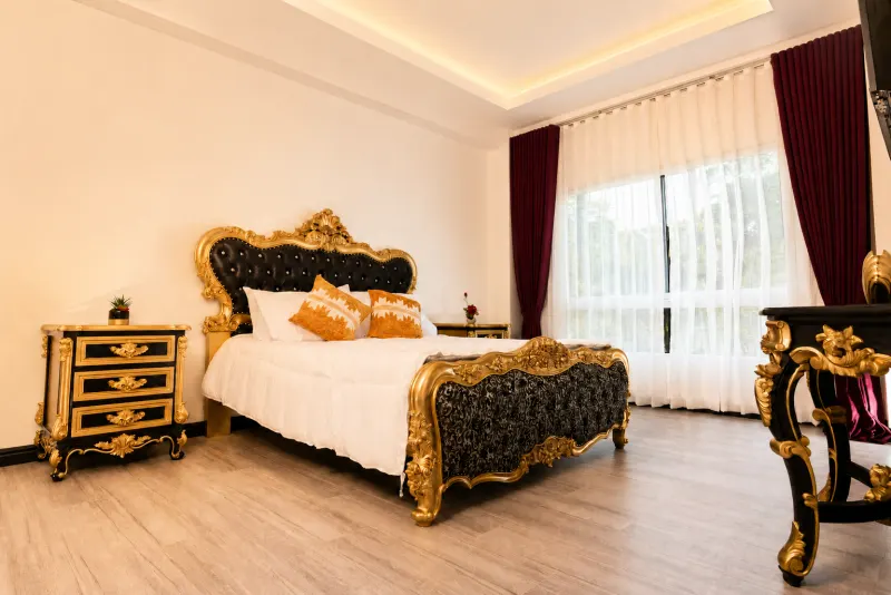 Bedroom with carved gold bedstead