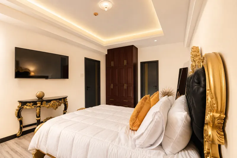 Bedroom with gold mirror and television