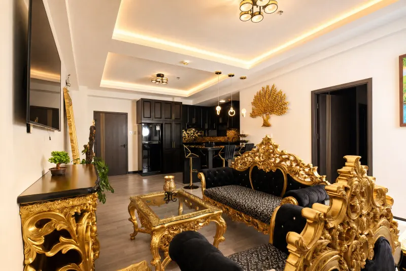 Open living and kitchen in black and gold