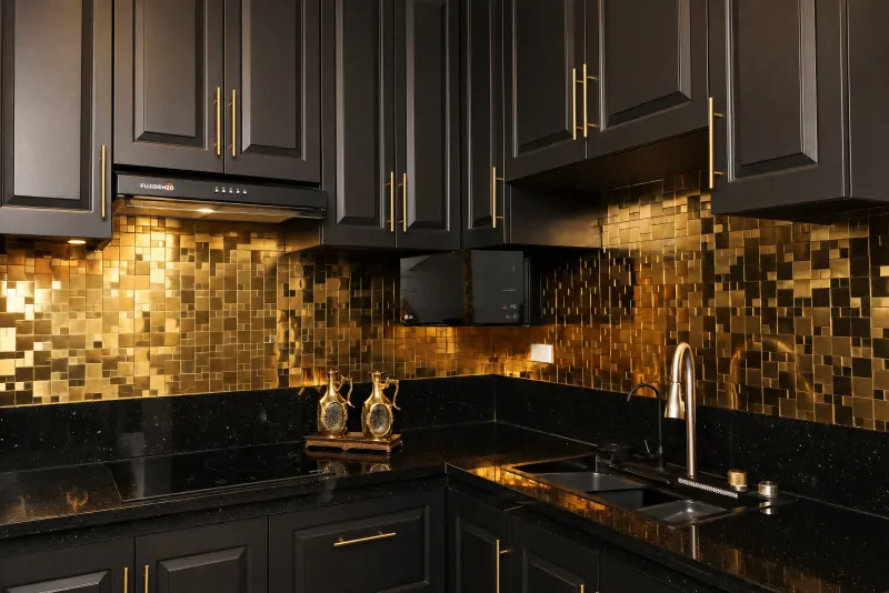 Black kitchen with gold mosaic backsplash