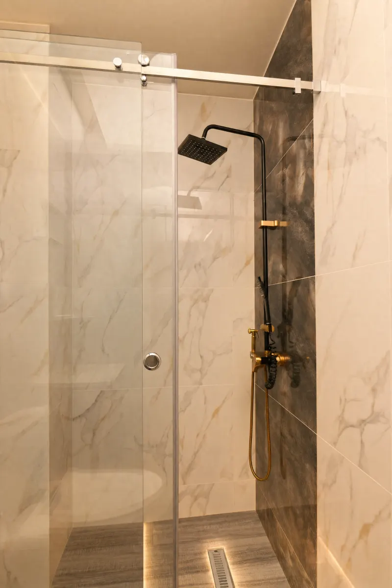 Walk-in shower framed in marble