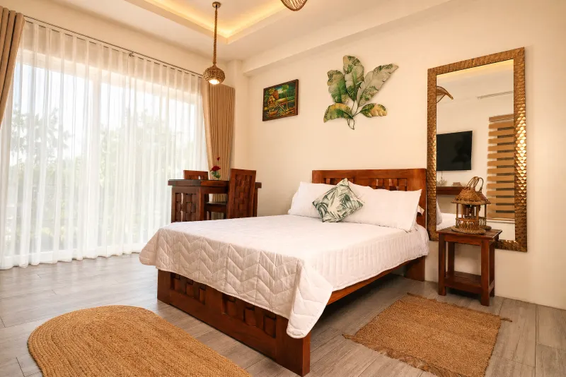 Studio bedroom with balcony doors and morning light