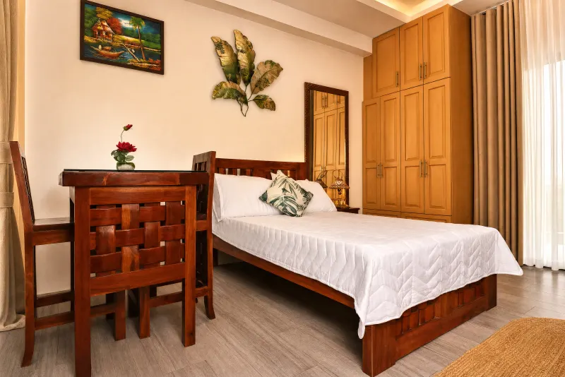 Bedroom with hardwood dining set and full wardrobe