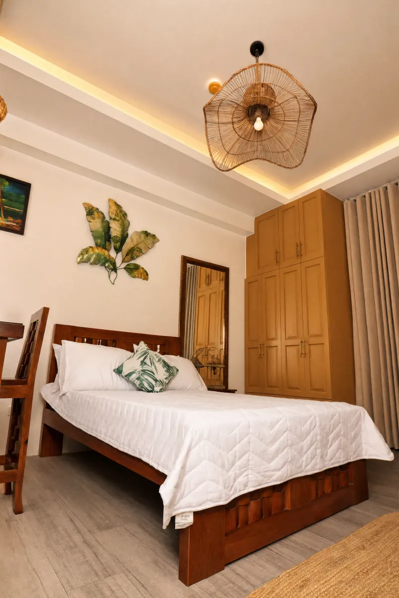 Bed beneath a woven rattan pendant