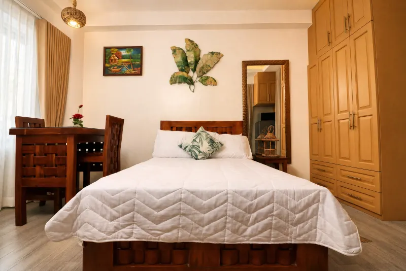Studio bedroom with wardrobe and dining nook